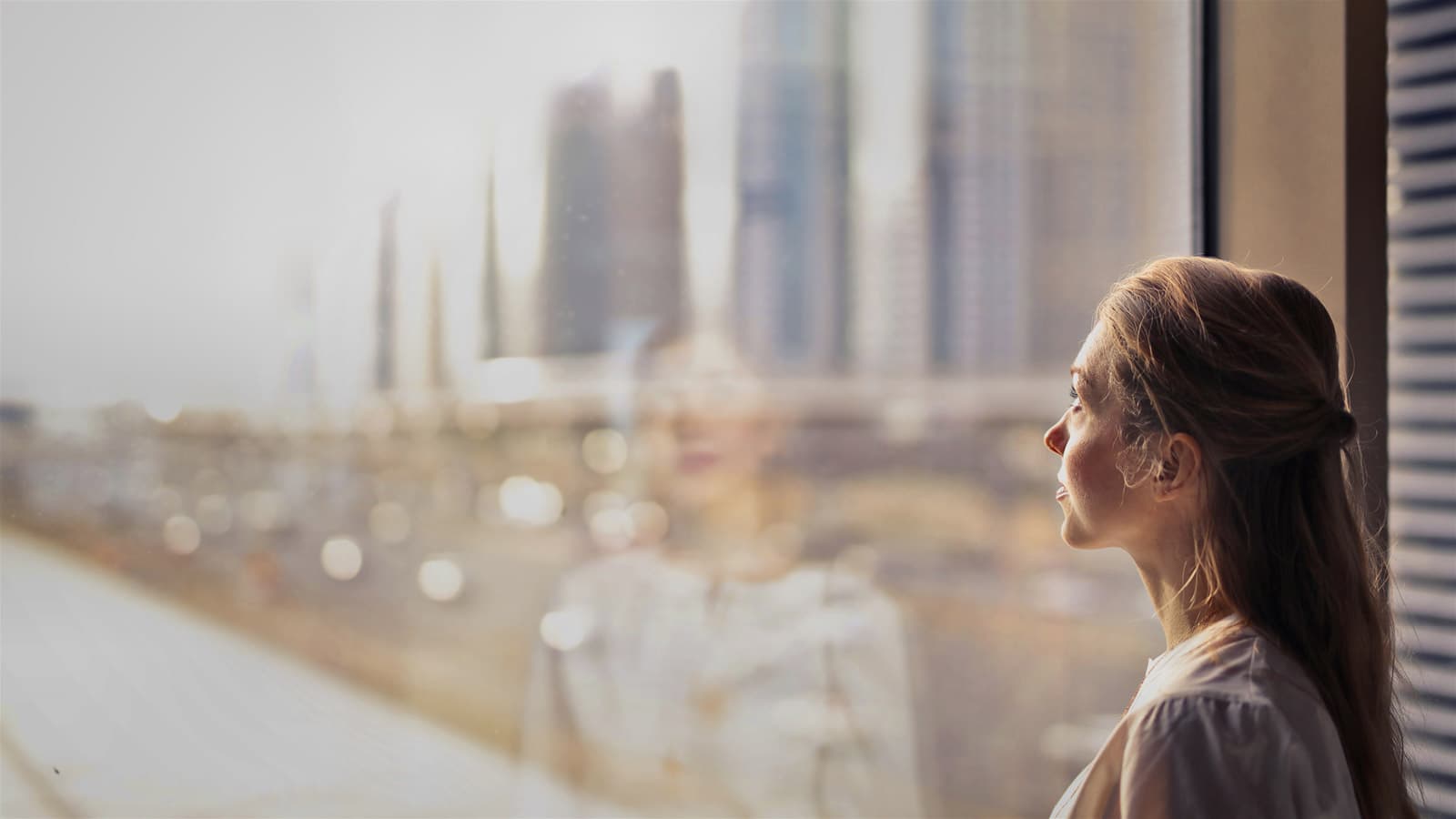 Female contemplating looking out of window